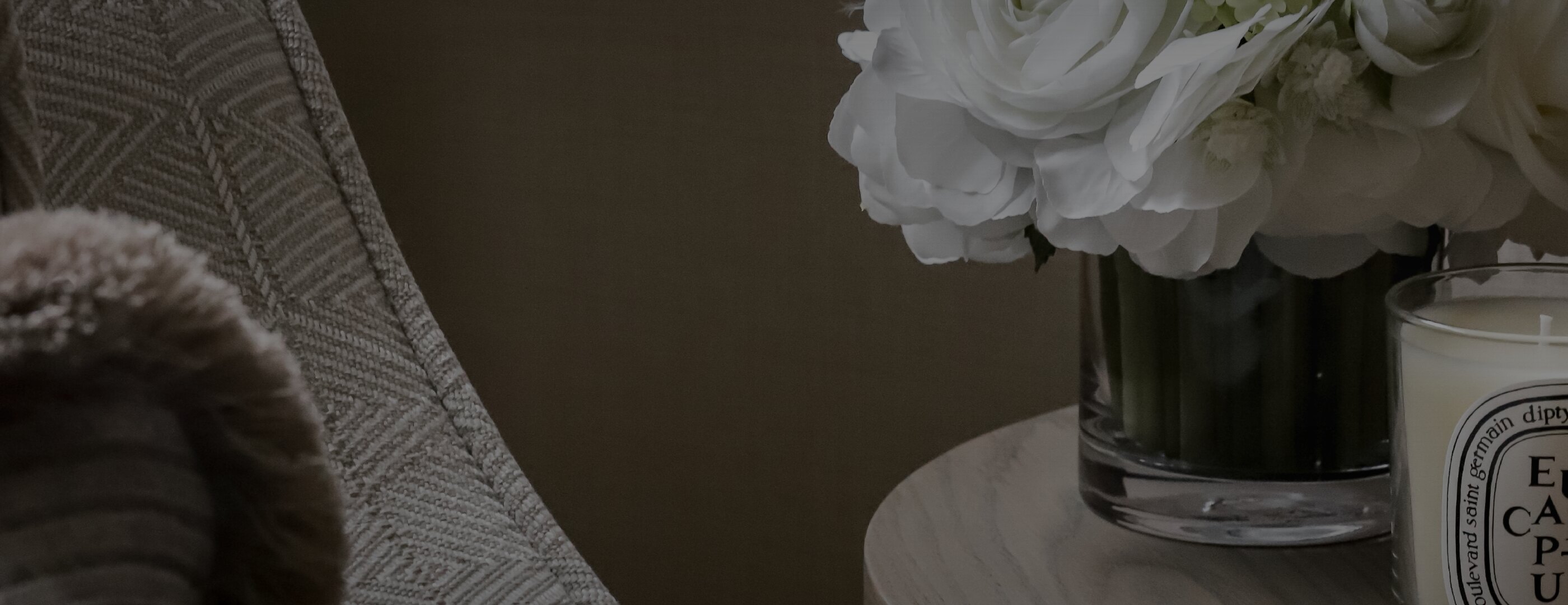 Projects hero close-up with cushion, flowers and candle